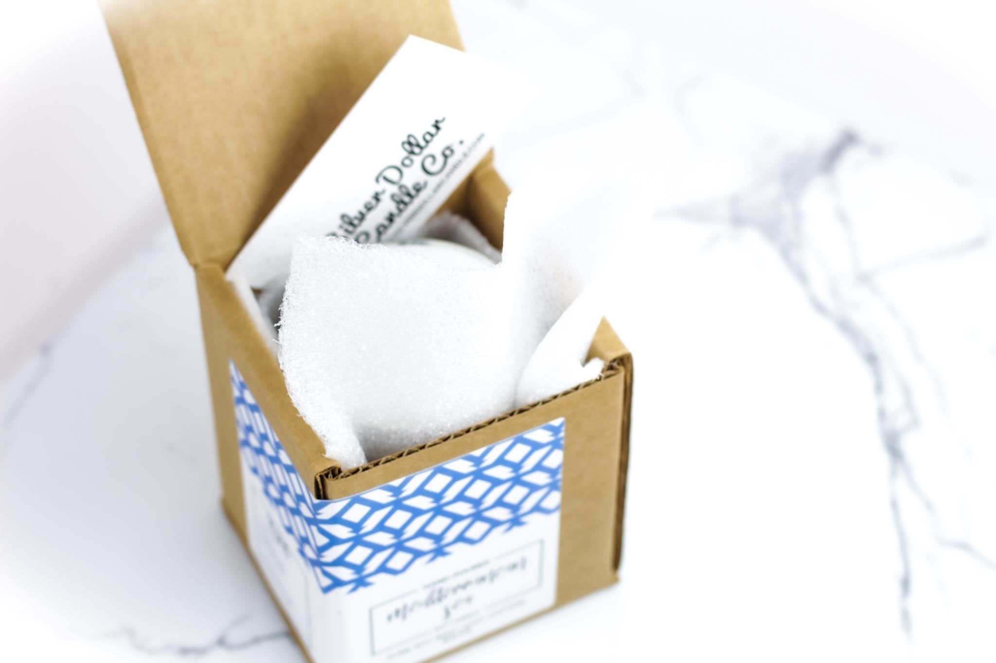 A beautifully designed candle labeled 'I Enjoy Long Walks Through The Bookstore' with a cozy ambiance, showcasing its elegant packaging and personalization option.